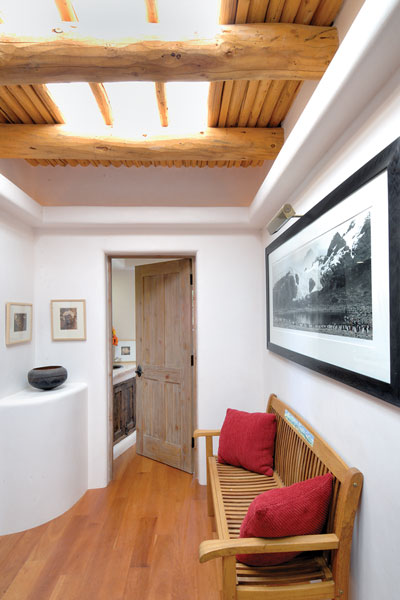 Vigas and el latillas, or peeled sticks, fram a skylight in the hallway of the house.